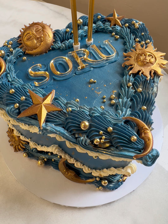 Soru Blue and gold celestial theme vintage style cake with gold suns and moons and stars 