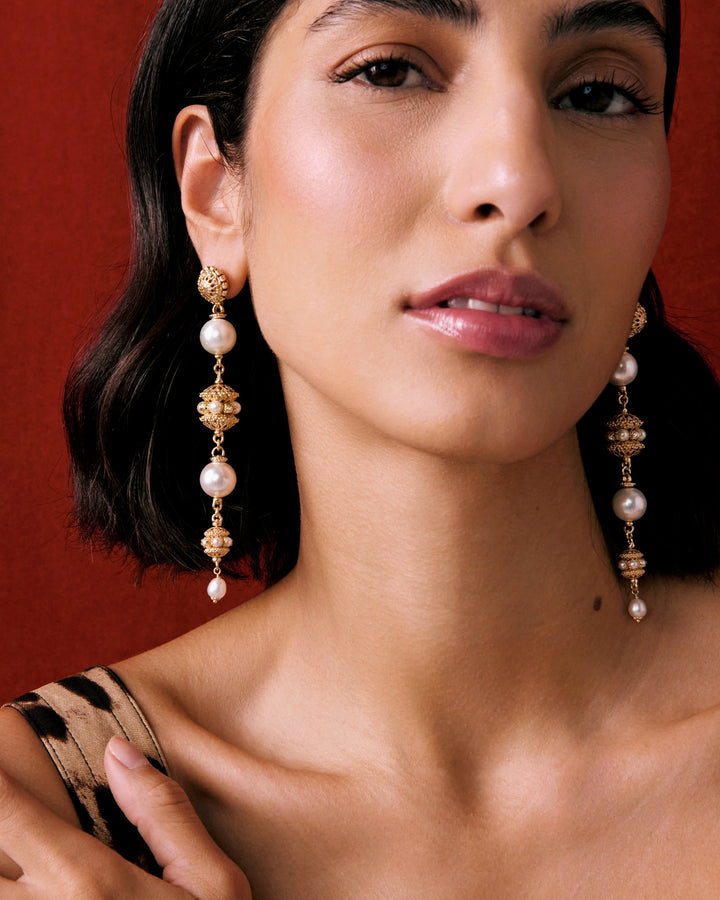 Statement drop pearl earrings worn by model