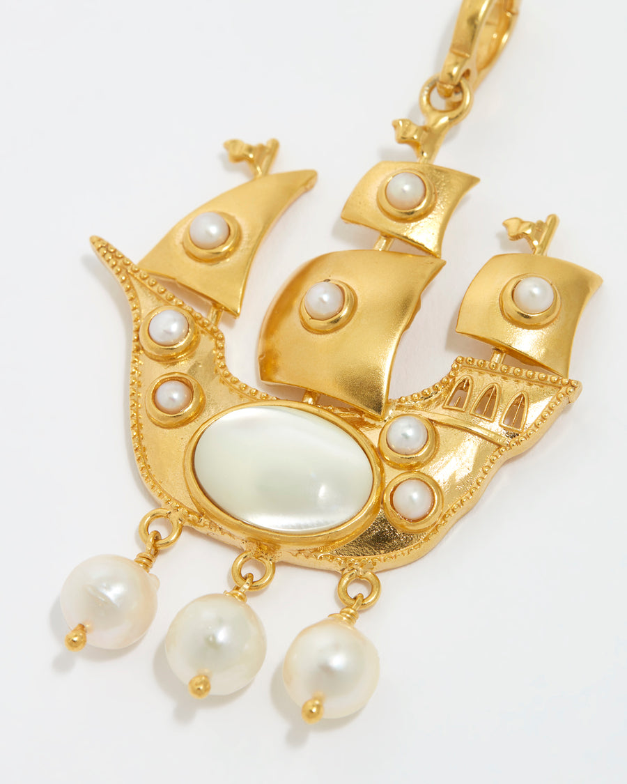 close up product shot of Soru Jewellery pearl embellished ship charm on a white background
