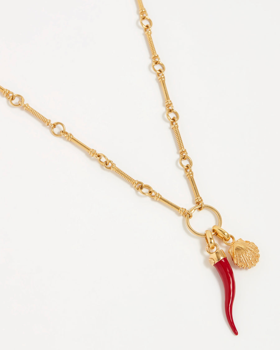 Image of a red coral Cornucopia horn shaped charm with gold top connector and a shell charm both hun from a gold bar necklace