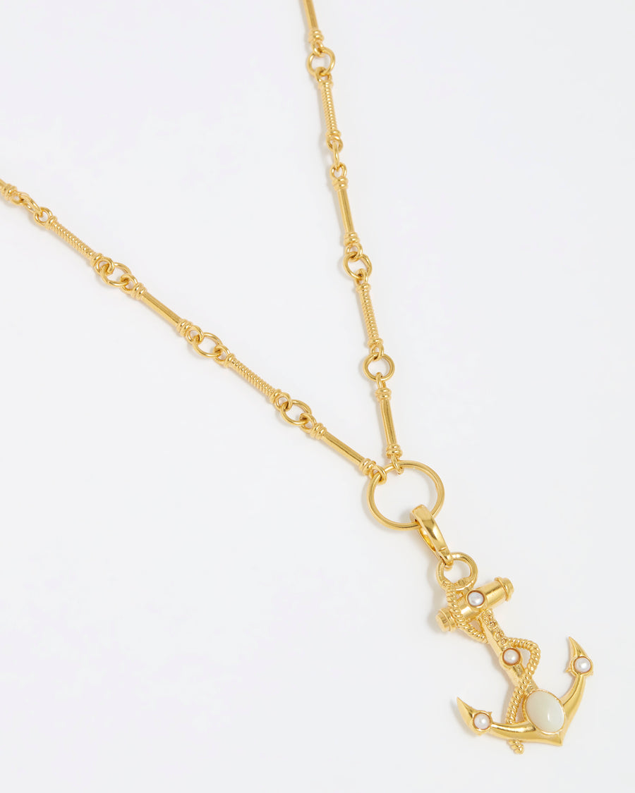 Product shot of gold anchor charm with white embellishments and rope twist detail hung from a gold chunky charm chain on white background