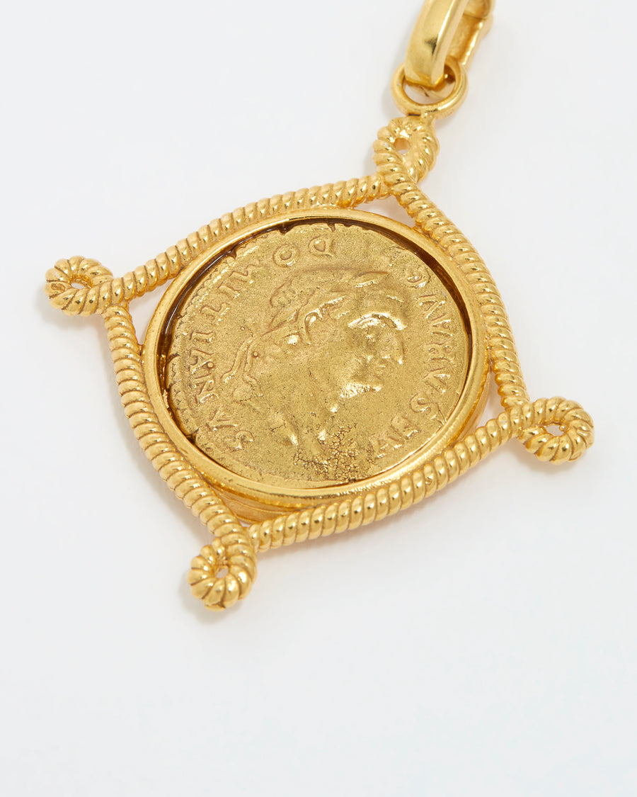 close up product shot of gold coin charm on a white background