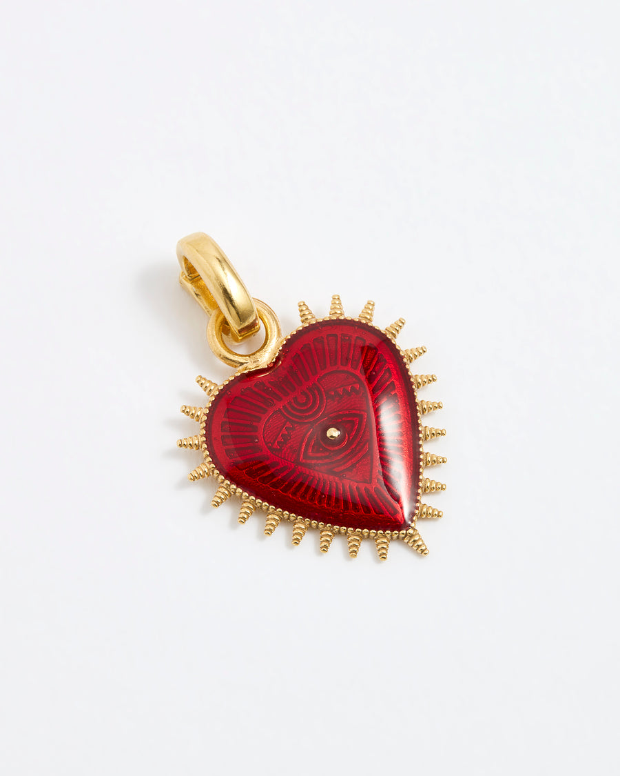 Product shot of a heart-shaped pendant featuring a deep, glossy red patterned enamel centre. The heart is surrounded by a border of gold spikes that extend outward from the edges.