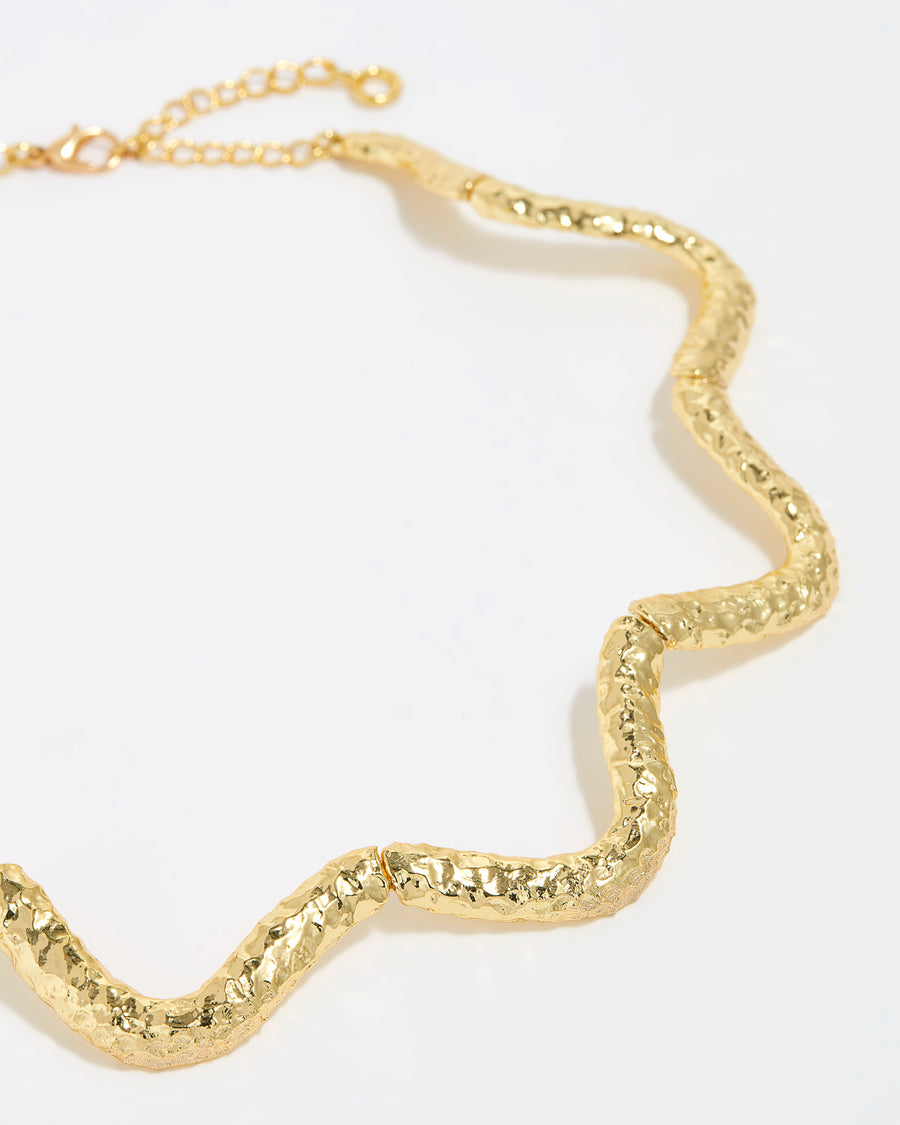 close up of textured curved gold necklace