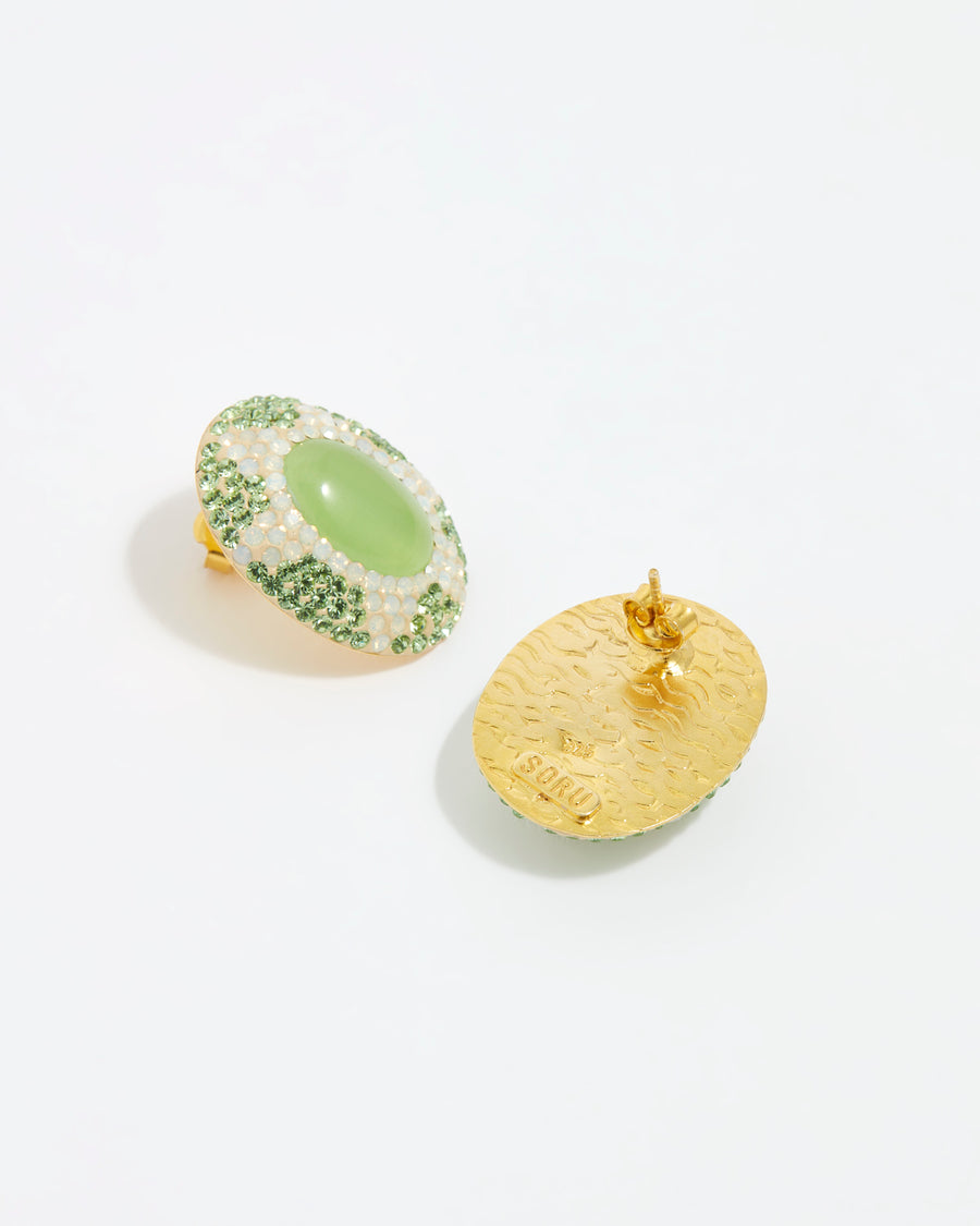 Close up front and reverse view overhead image oval stud earrings featuring a vibrant green cats eye stone surrounded by sparkling green and opal crystals set with a sun motif on a white background