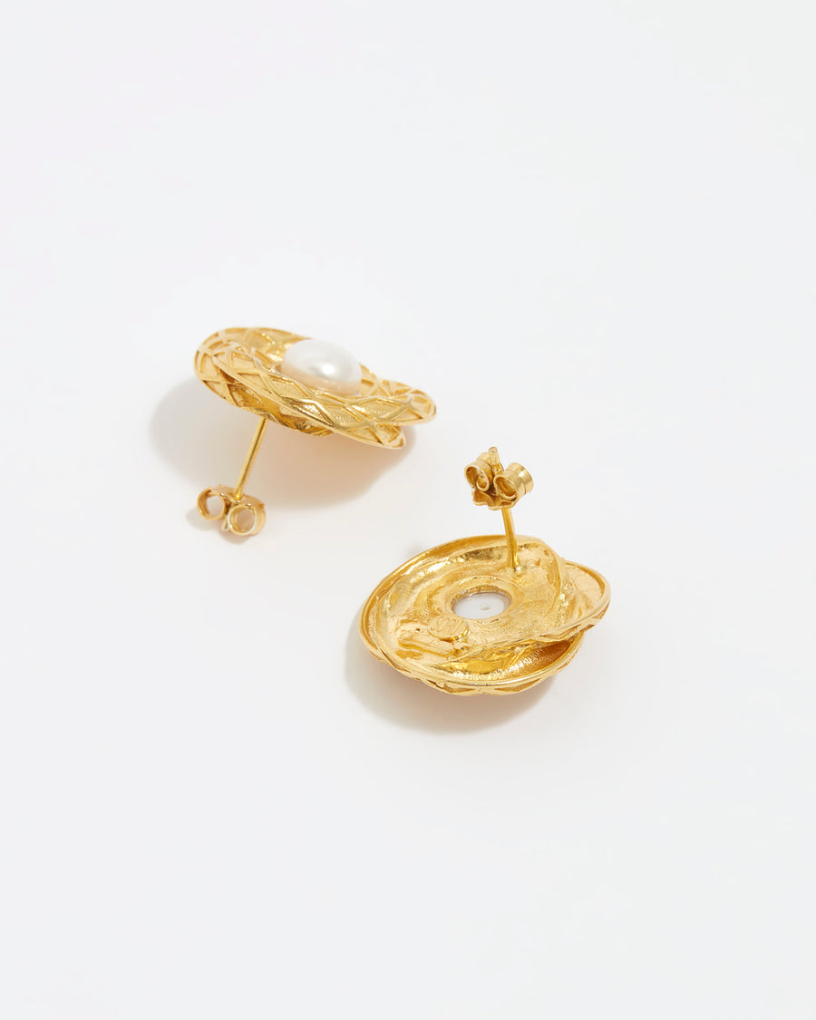 close up image shot of side and reverse view of round gold textured earrings with centre pearl on a white back ground