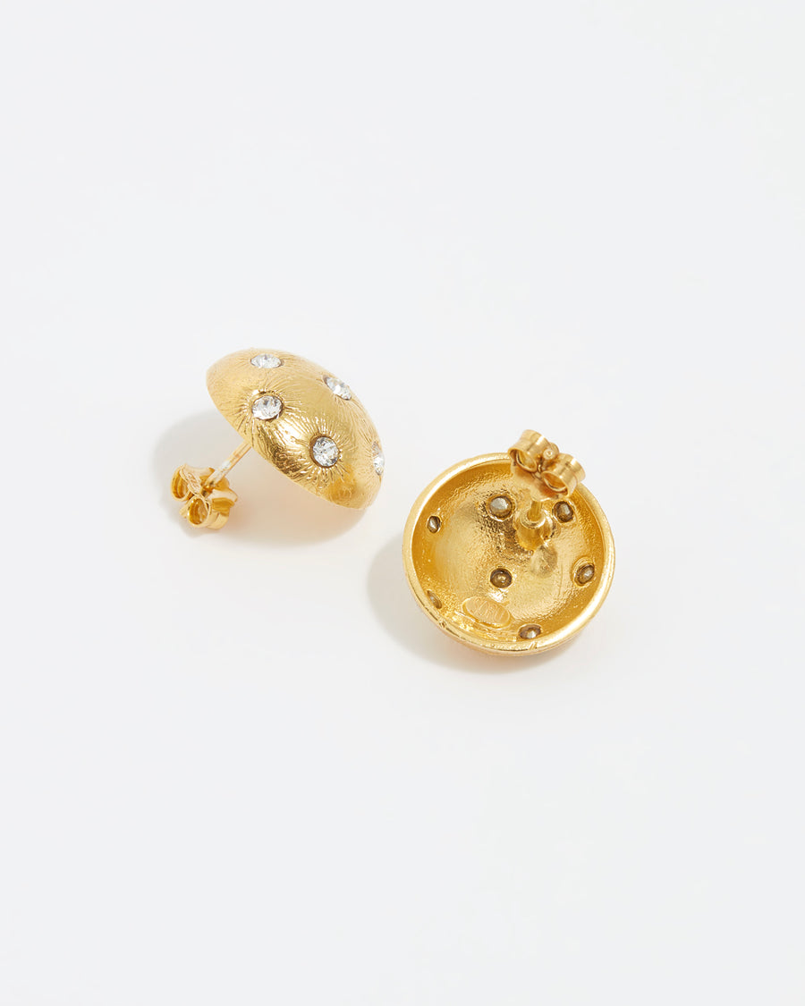 close up image shot of side and reverse view of round gold star etched earrings with clear crystal embellishment on a white back ground