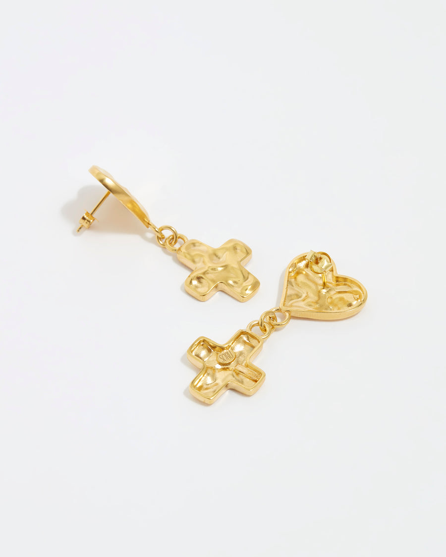 Overhead image of reverse view of soru jewellery textured heart and cross earrings on a white background