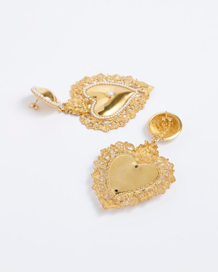 Product shot of gold traditional burning heart statement earrings with pearl detailing.