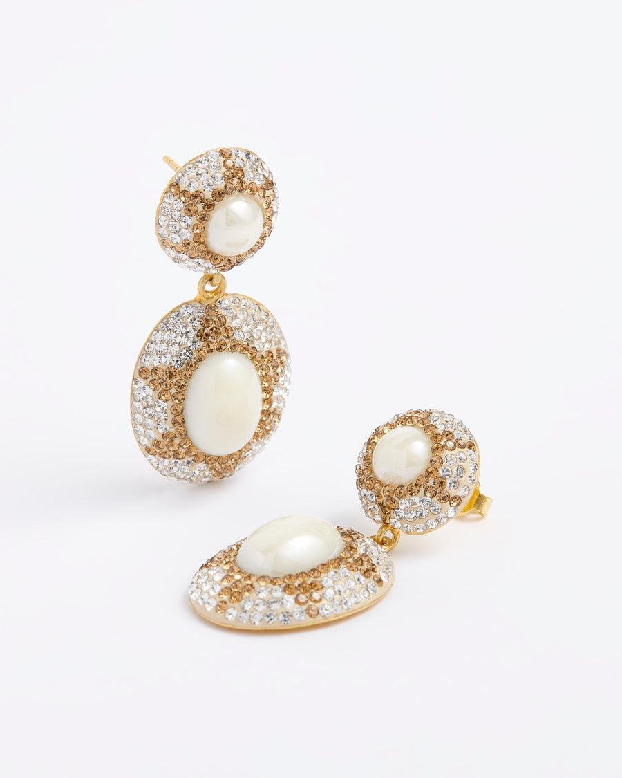 Product shot of double drop statement earrings, featuring Majorca pearl gemstones with golden and clear sparkling crystals forming a sun motif, on a white background.