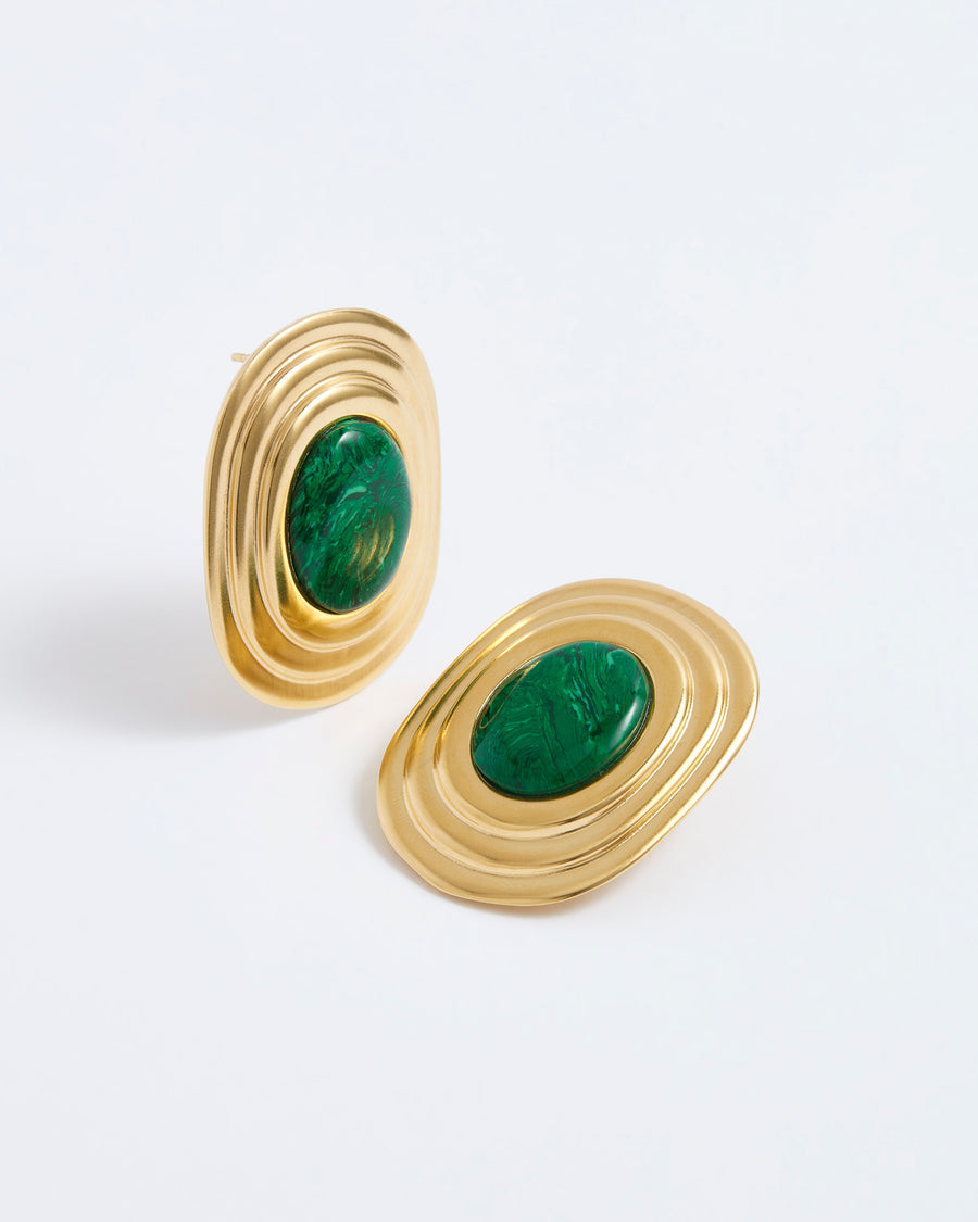 Statement gold earrings with ridged edge and bold green centre, on white background