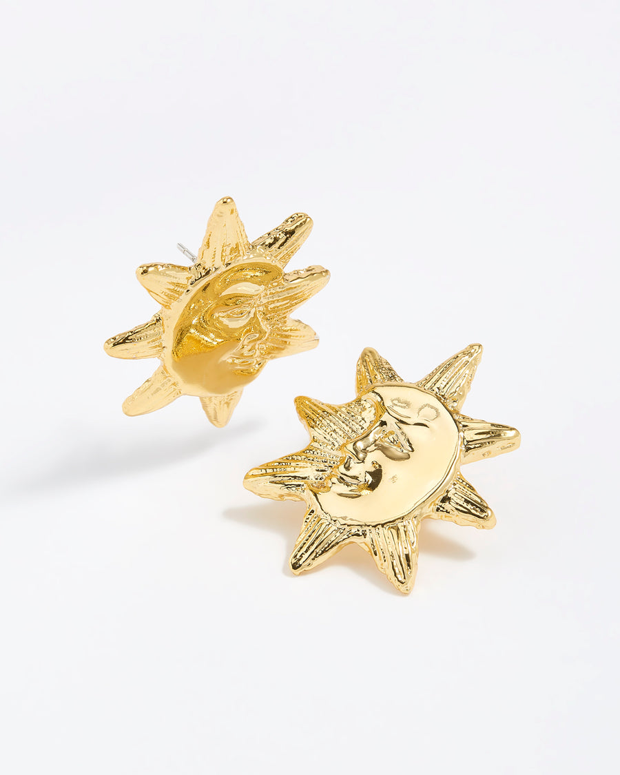 Product shot of gold celestial moon and sunshine etched stud earrings.