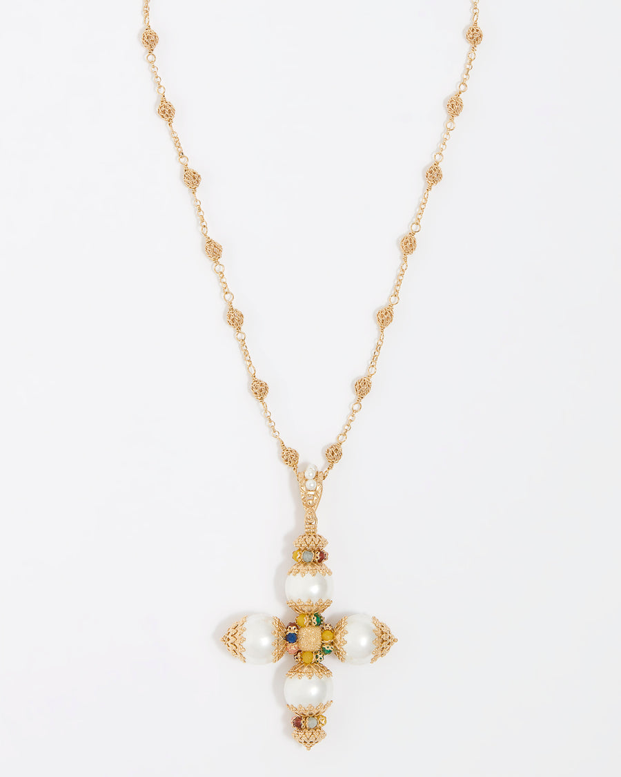 Close up product shot of a gold cross  pendant necklace. Features pastel coloured agate gemstones, pearls and intricate filigree hung from a textured beaded chain on a white background.