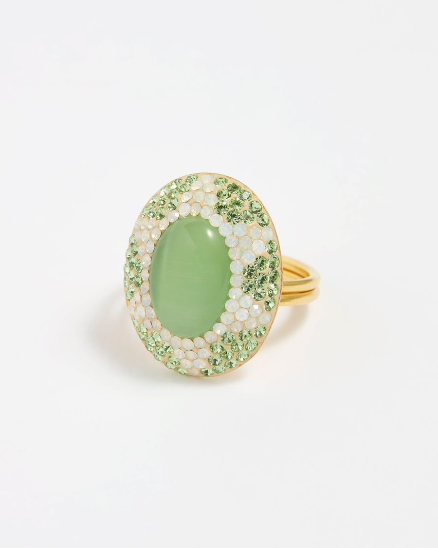 Close up product shot of green crystal adjustable ring with large green centre stone surrounded by crystals on a white background