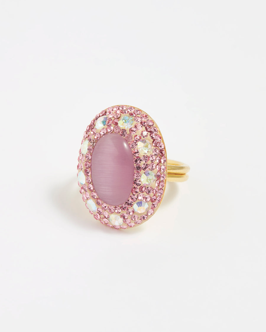 Close up product shot of adjustable ring  with pink centre stone surrounded by crystals on a white background