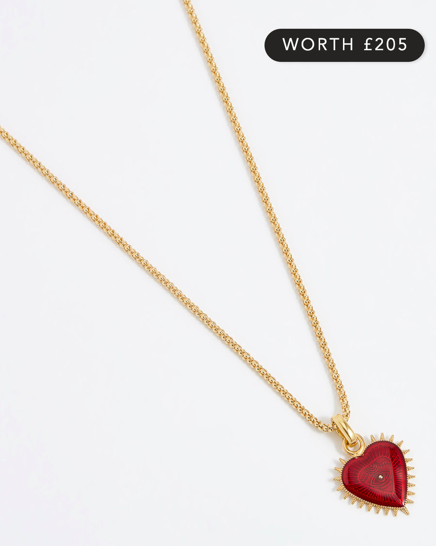 Product shot of Soru Jewellery red heart charm hung from a rope charm chain on white background