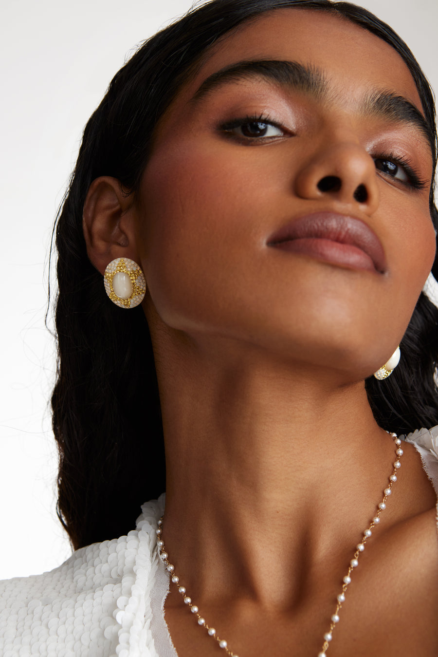 model shot wearing the soru jewellery large stud central pearl surrounded by crystals with a pearl necklace