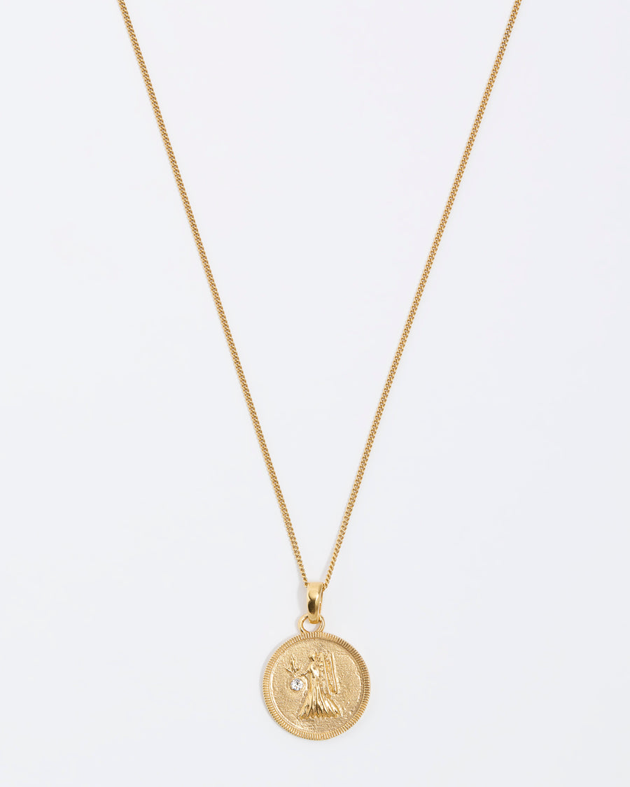 Virgo Zodiac circular gold pendant on a fine gold chain necklace.