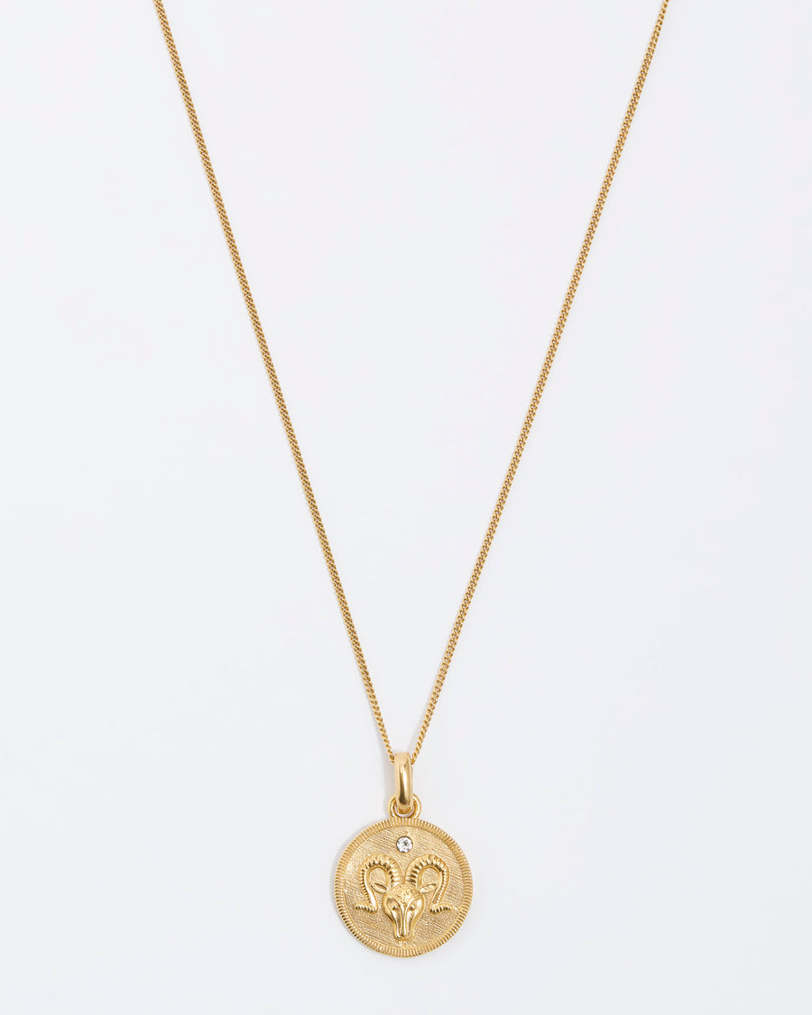 Aries Zodiac circular gold pendant on a fine gold chain necklace.