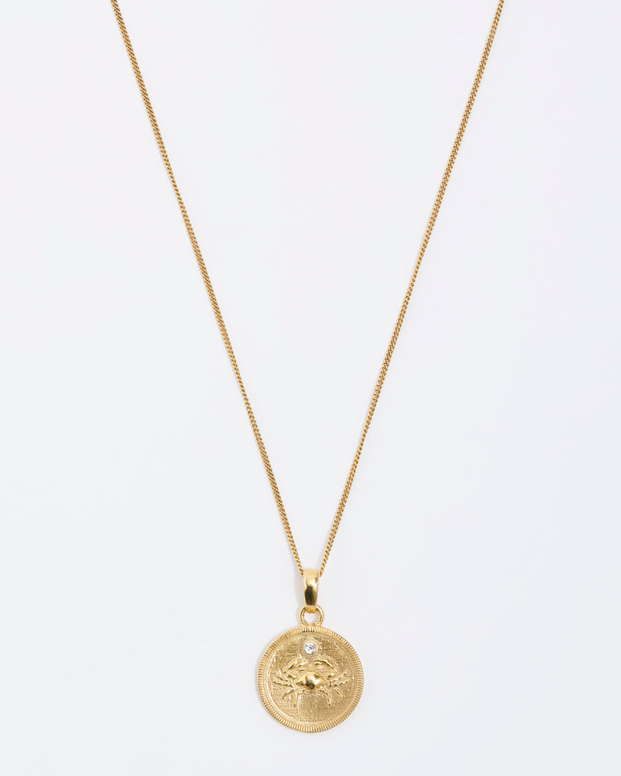 Cancer crab Zodiac circular gold pendant on a fine gold chain necklace.