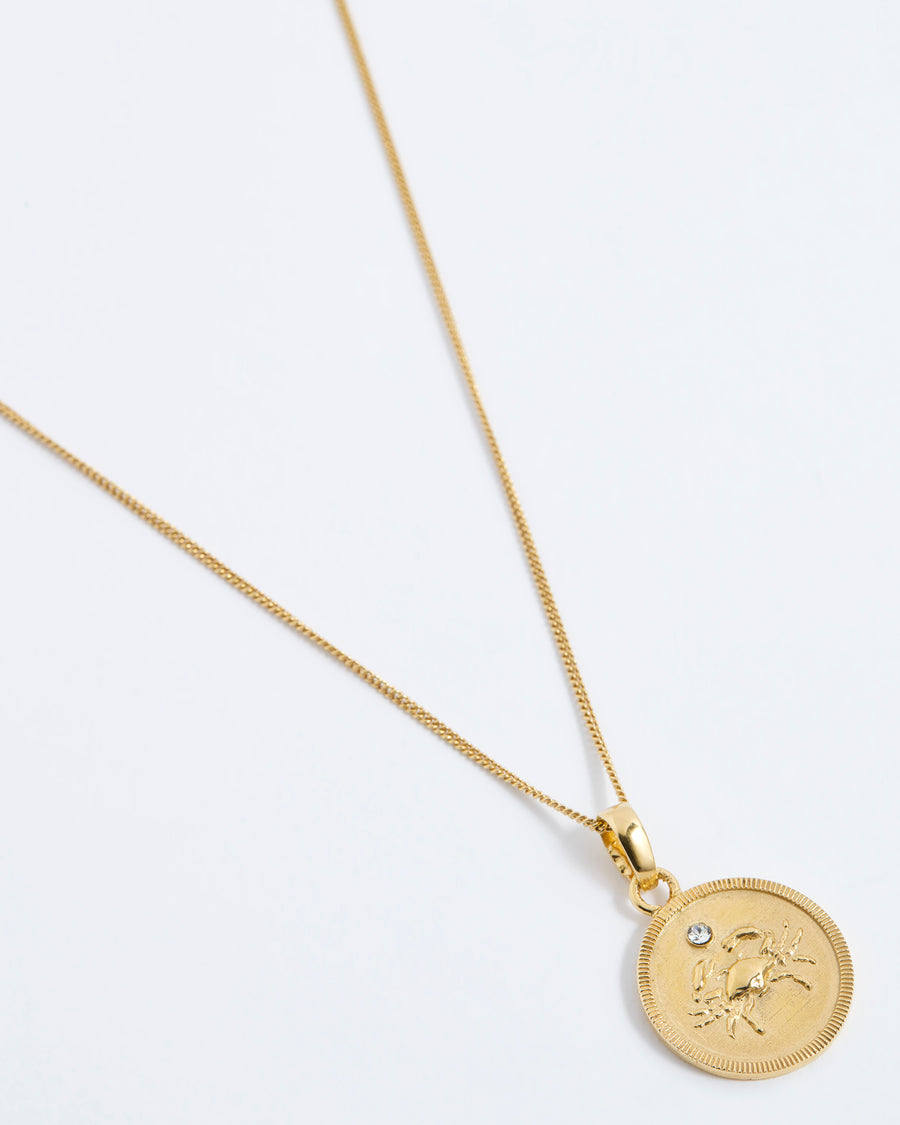 cancer crab Zodiac circular gold pendant on a fine gold chain necklace.