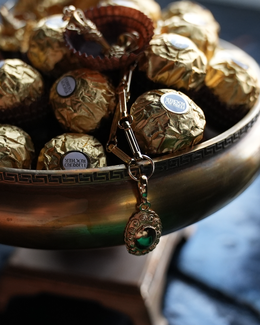 Pendant charm necklace on a bowl full of chocolates