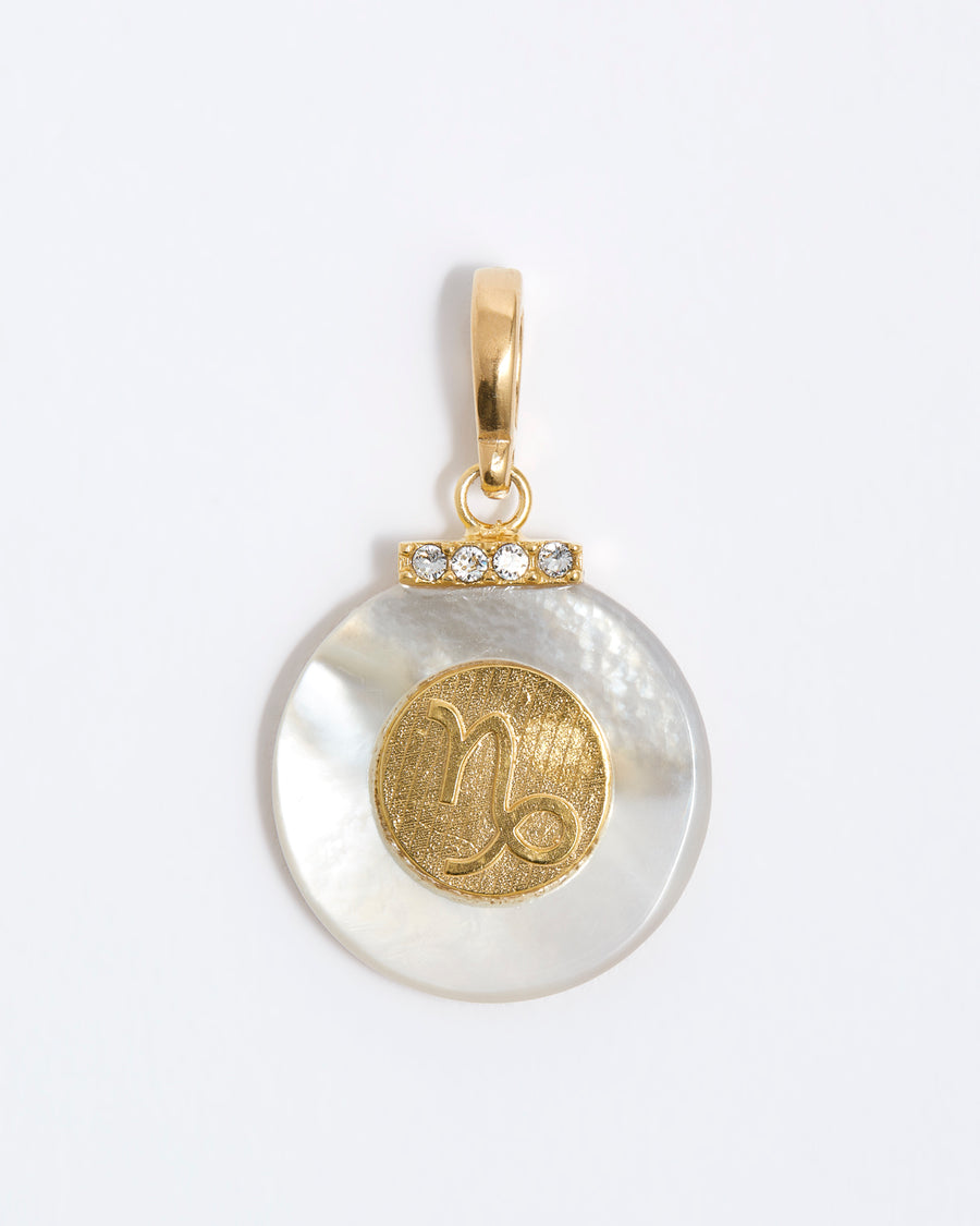 product shot - Capricorn engraved gold coin with chunky pearl outer and diamond detailing placed on a white background