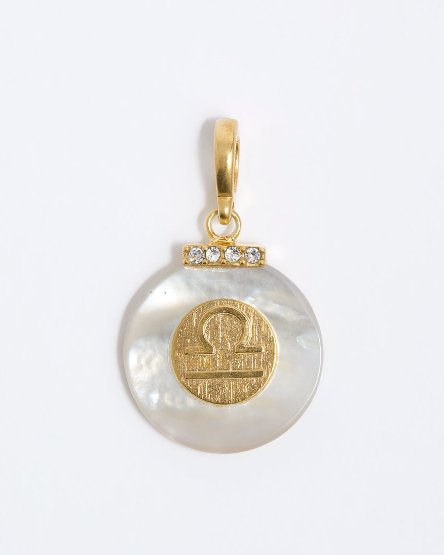 product shot - Libra engraved gold coin with chunky pearl outer and diamond detailing placed on a white background