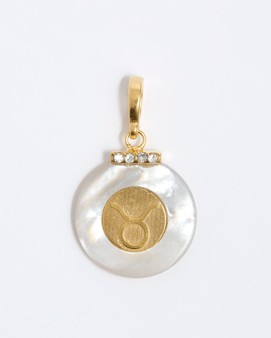 product shot - Taurus engraved gold coin with chunky pearl outer and diamond detailing placed on a white background