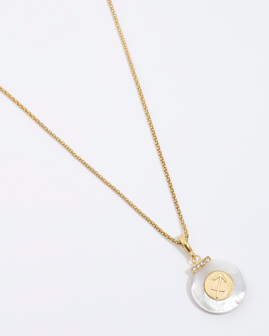 Product shot - Sagittarius engraved gold coin with chunky pearl outer and diamond detailing, on a gold rope chain, placed on a white background